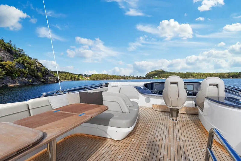 S72515 Yacht Photos Pics Luxurious 2023 Princess S72 yacht deck with seating, table, and scenic water view.