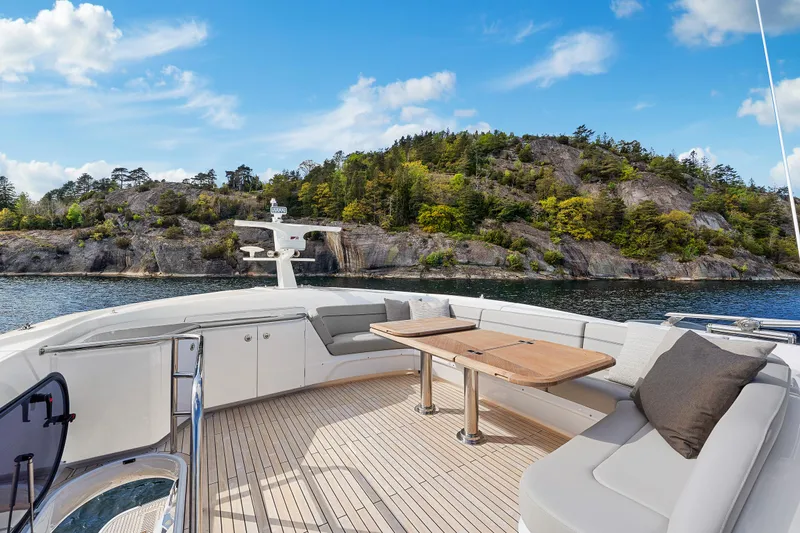 S72515 Yacht Photos Pics Luxury Princess S72 yacht deck with seating, table, and scenic coastal view, 2023 model.
