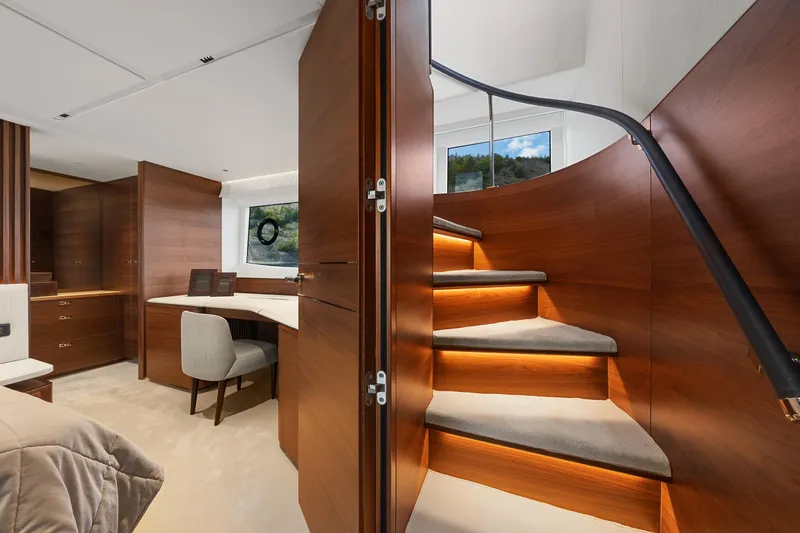 S72515 Yacht Photos Pics Luxurious interior of 2023 Princess S72 yacht with elegant wooden staircase and modern furnishings.