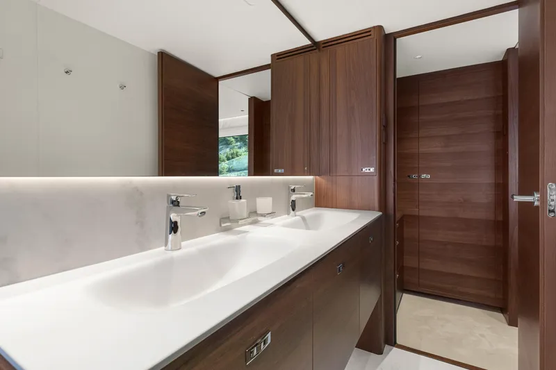 S72515 Yacht Photos Pics Luxurious bathroom in 2023 Princess S72 yacht with dual sinks and wooden cabinetry.