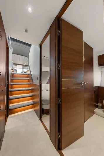 S72515 Yacht Photos Pics Interior view of 2023 Princess S72 yacht, featuring elegant wooden doors and staircase.