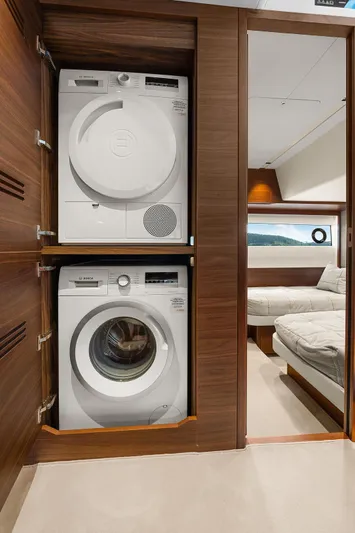 S72515 Yacht Photos Pics Laundry area with stacked washer and dryer in 2023 Princess S72 yacht.