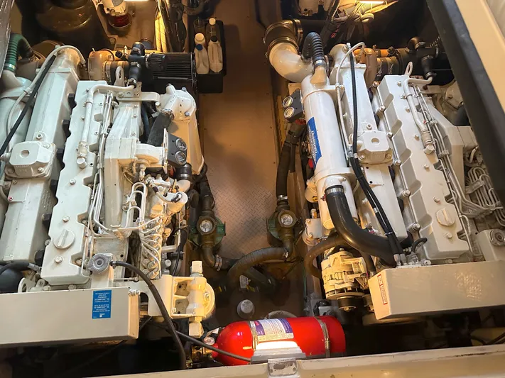 Messing About Yacht Photos Pics Engine room of 2003 Sea Ray 400 Sedan Bridge with dual engines and fire extinguisher.