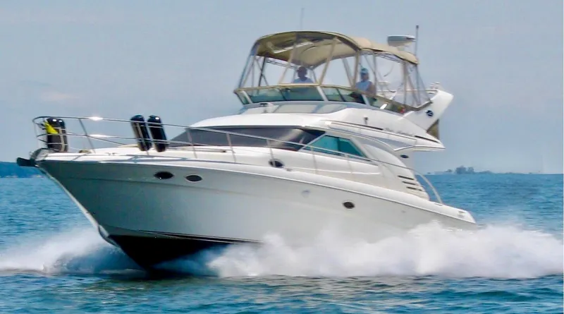 Messing About Yacht Photos Pics 2003 Sea Ray 400 Sedan Bridge yacht cruising on open water.