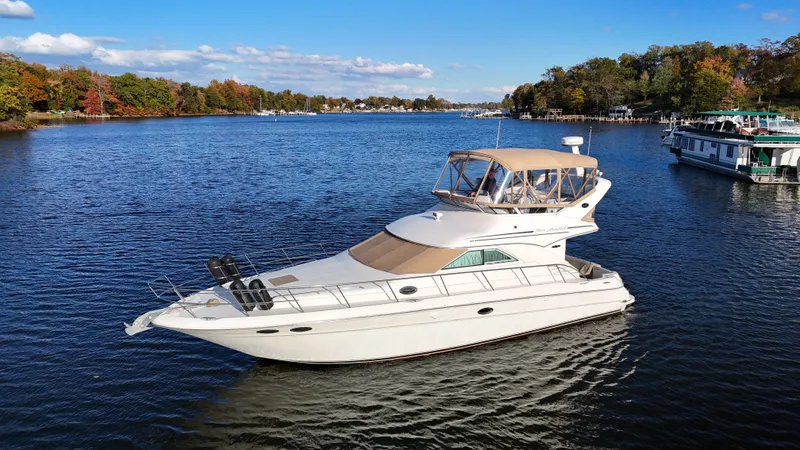 Messing About Yacht Photos Pics 2003 Sea Ray 400 Sedan Bridge yacht cruising on a scenic lake.