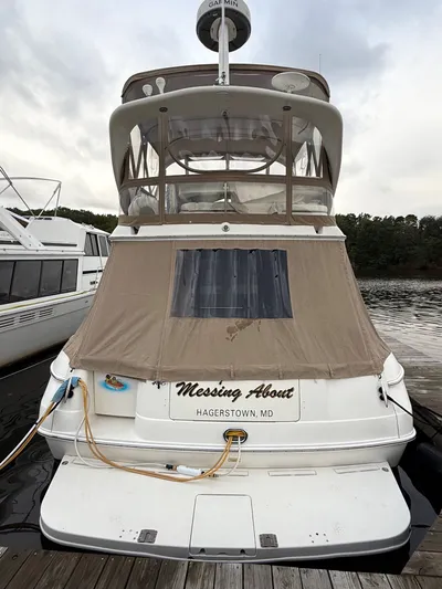 Messing About Yacht Photos Pics 2003 Sea Ray 400 Sedan Bridge docked, rear view with canvas cover, "Messing About" name visible.