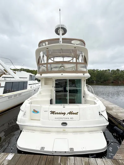 Messing About Yacht Photos Pics 2003 Sea Ray 400 Sedan Bridge docked, rear view, with "Messing About" name.