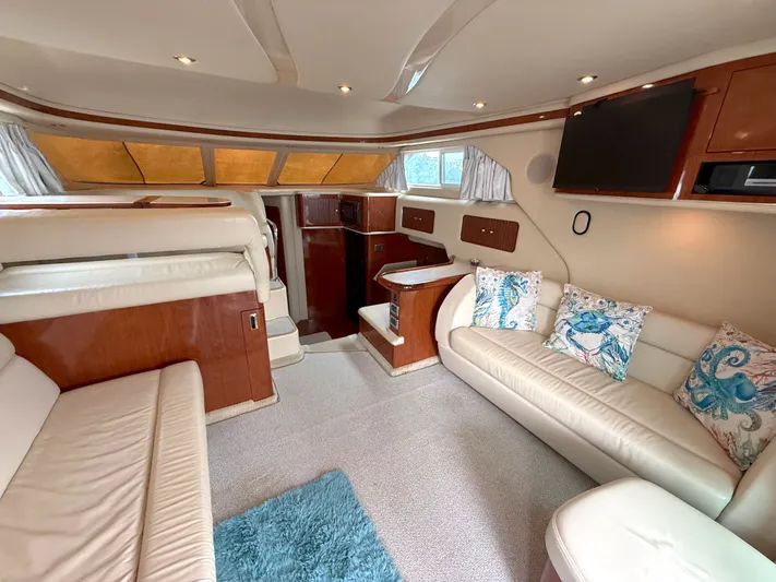 Messing About Yacht Photos Pics Luxurious interior of 2003 Sea Ray 400 Sedan Bridge yacht with plush seating and elegant decor.