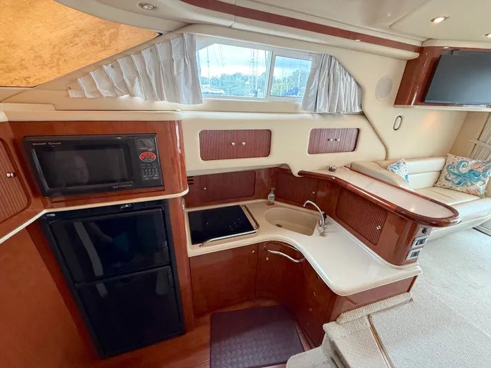 Messing About Yacht Photos Pics Luxurious 2003 Sea Ray 400 Sedan Bridge yacht interior with kitchen and seating area.