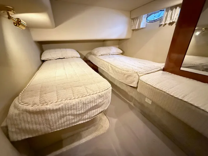 Messing About Yacht Photos Pics Twin beds in the cozy cabin of a 2003 Sea Ray 400 Sedan Bridge yacht.