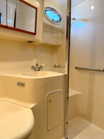 Messing About Yacht Photos Pics 2003 Sea Ray 400 Sedan Bridge bathroom with sink, mirror, and shower area.