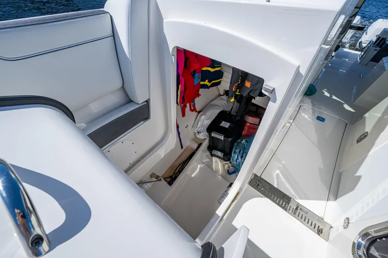 Never Say Never Yacht Photos Pics 2021 Tiara Yachts 34 LX storage compartment with life jackets and equipment.