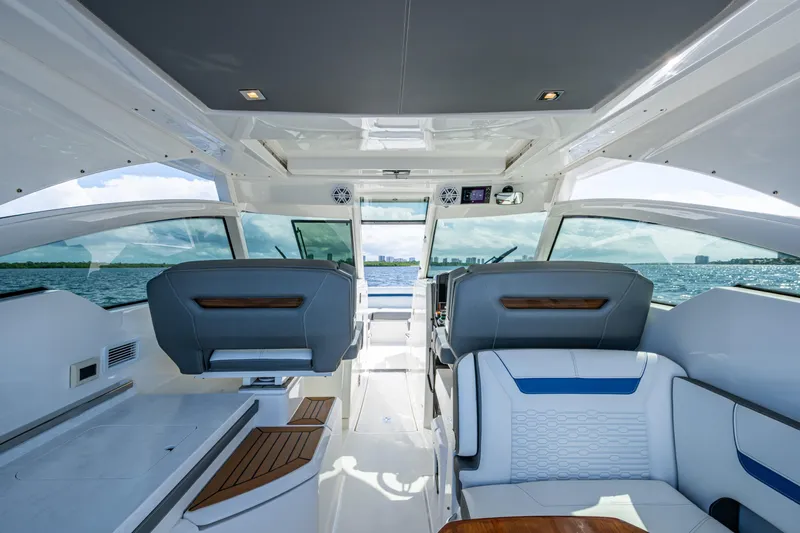 Never Say Never Yacht Photos Pics 2021 Tiara Yachts 34 LX interior with modern seating and ocean view.