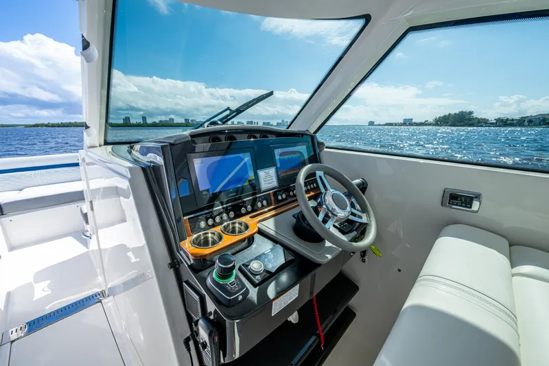 Never Say Never Yacht Photos Pics 2021 Tiara Yachts 34 LX helm with modern controls and ocean view.