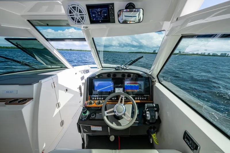 Never Say Never Yacht Photos Pics 2021 Tiara Yachts 34 LX helm with advanced navigation systems on open water.