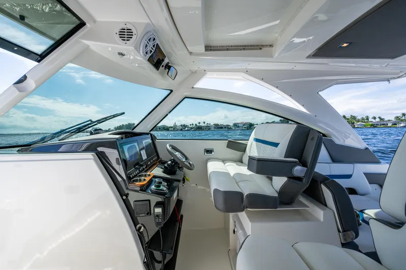 Never Say Never Yacht Photos Pics Interior of 2021 Tiara Yachts 34 LX, featuring modern helm and seating.