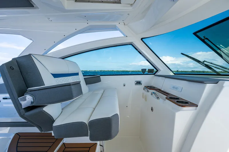 Never Say Never Yacht Photos Pics 2021 Tiara Yachts 34 LX interior with luxurious seating and ocean view.