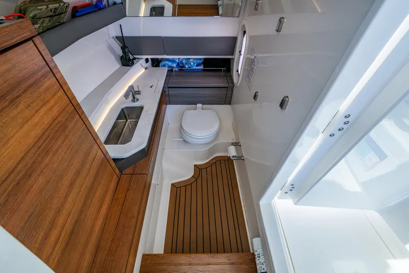Never Say Never Yacht Photos Pics 2021 Tiara Yachts 34 LX bathroom with modern fixtures and wooden accents.