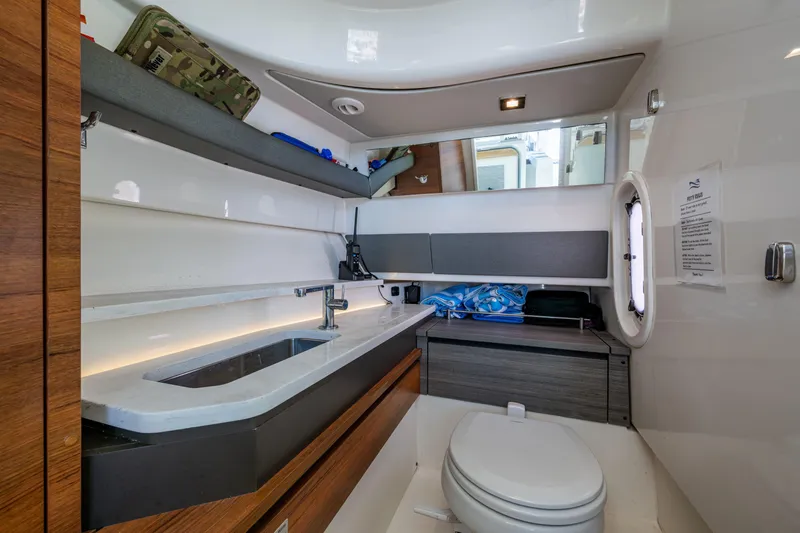Never Say Never Yacht Photos Pics Luxurious bathroom interior of 2021 Tiara Yachts 34 LX, featuring modern amenities and sleek design.