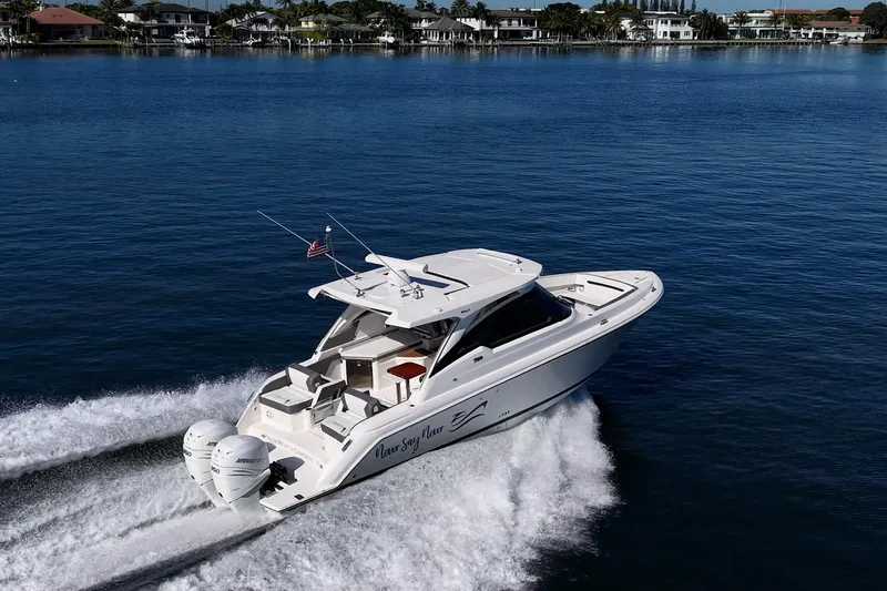 Never Say Never Yacht Photos Pics 2021 Tiara Yachts 34 LX cruising on a serene blue lake.