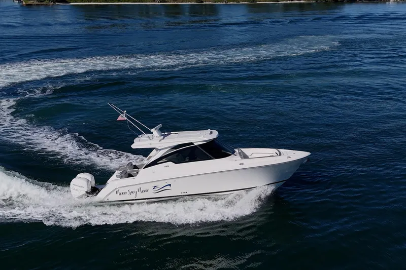Never Say Never Yacht Photos Pics 2021 Tiara Yachts 34 LX cruising on open water, showcasing sleek design and performance.