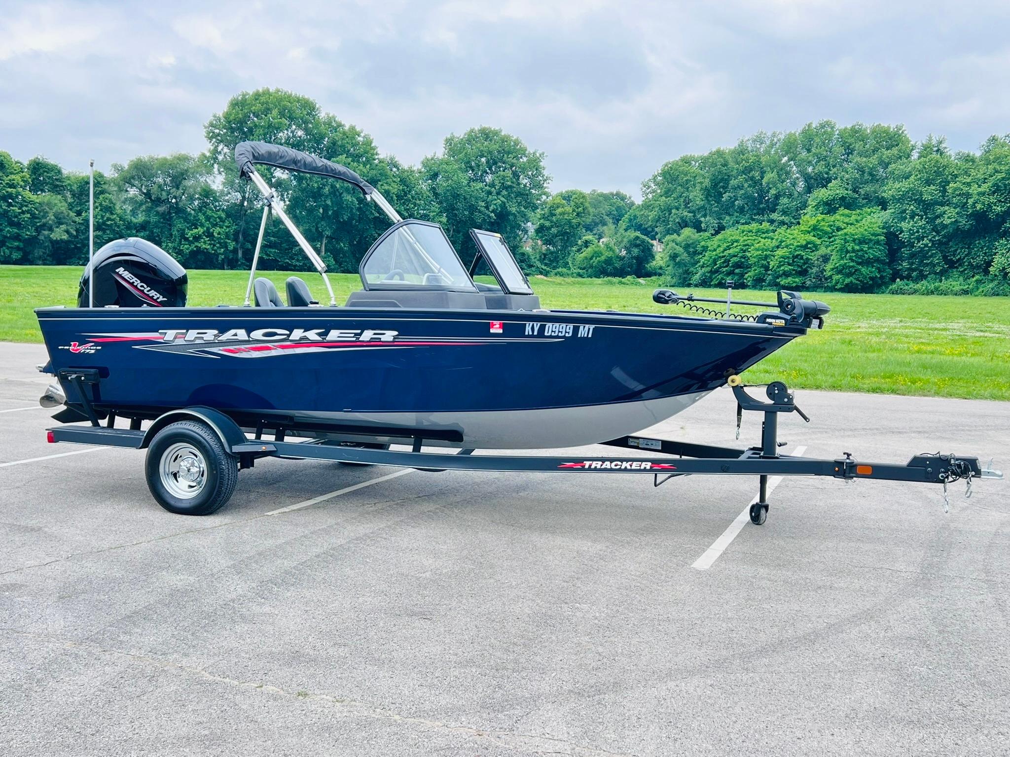 2023 Tracker Pro Guide V-175 WT boat on trailer in parking lot.
