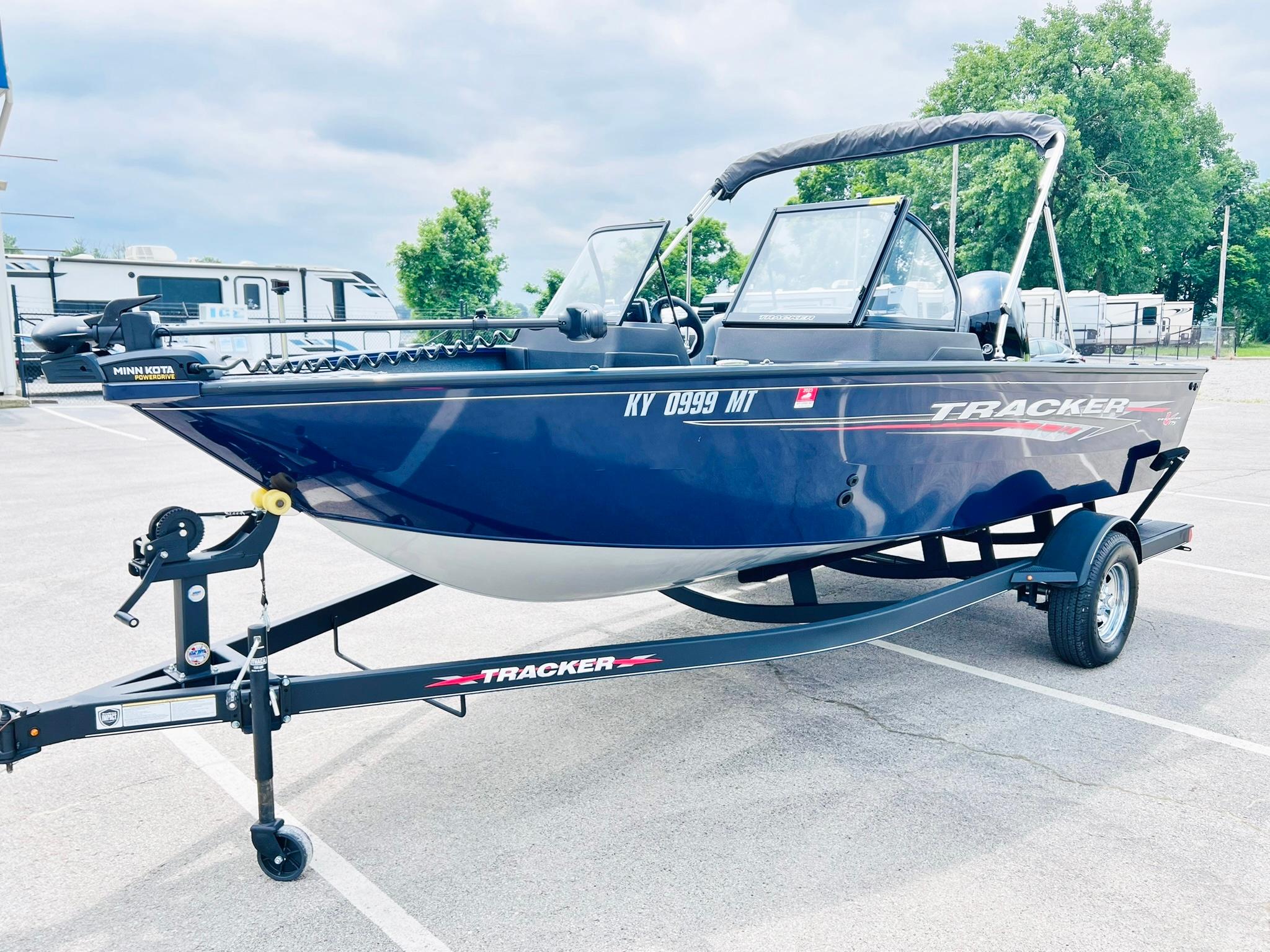2023 Tracker Pro Guide V-175 WT boat on trailer in parking lot.