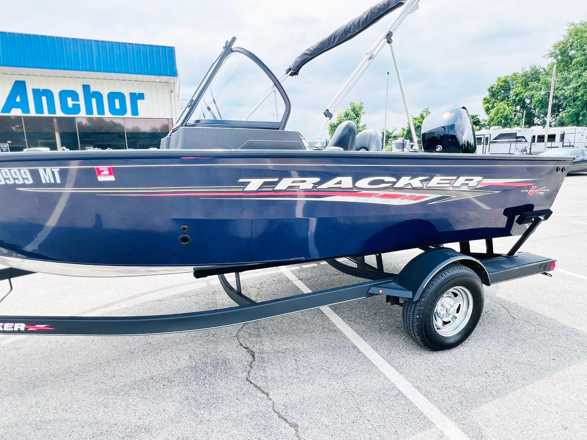 2023 Tracker Pro Guide V-175 WT boat on trailer in parking lot.