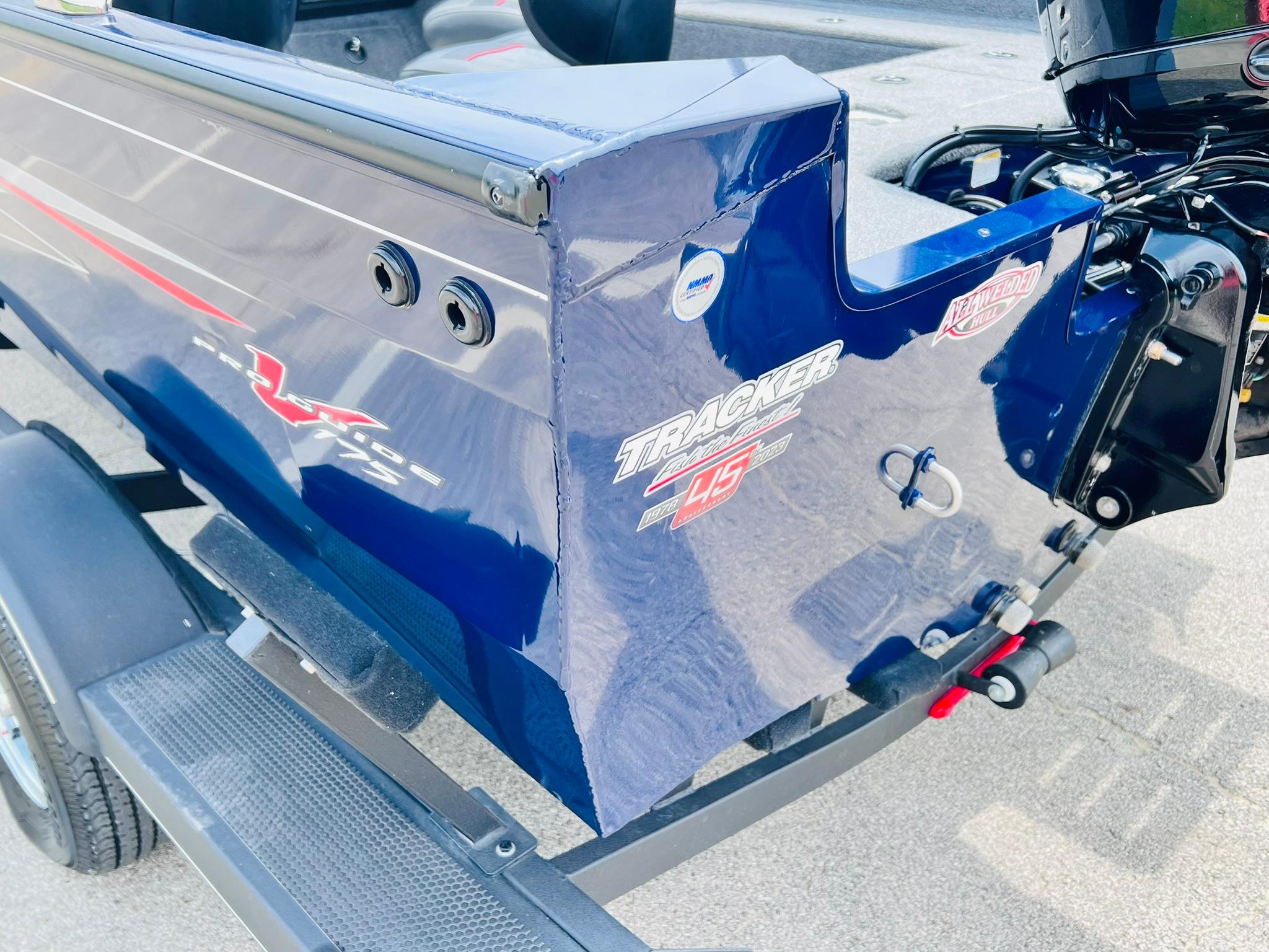2023 Tracker Pro Guide V-175 WT boat, blue exterior, on trailer, rear view with motor.