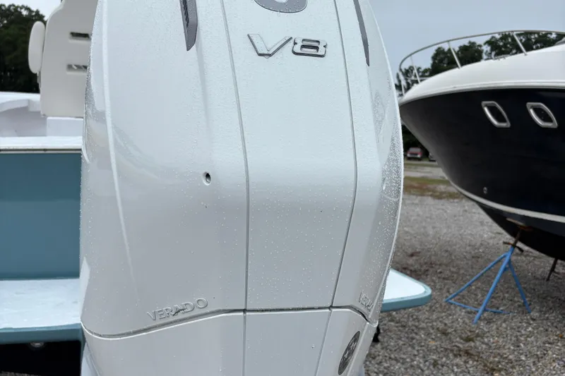  Yacht Photos Pics 2025 Weaver 270 boat with V8 Verado engine, parked on gravel near another boat.