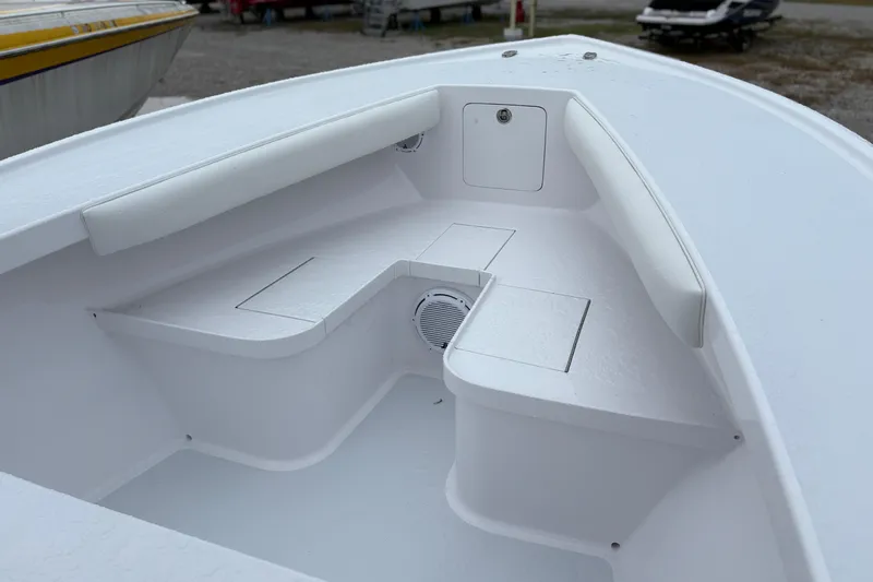  Yacht Photos Pics Bow seating area of 2025 Weaver 270 boat, featuring white cushioned seats and storage compartments.