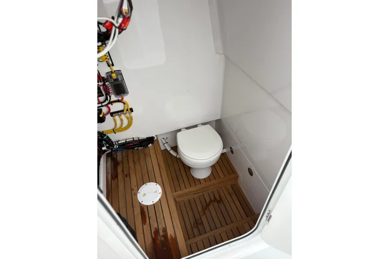  Yacht Photos Pics Compact marine bathroom with wooden flooring in a 2025 Weaver 270 boat.