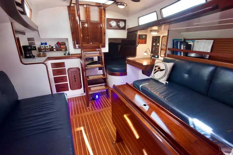 Volunteer Yacht Photos Pics Luxurious 1996 Custom Bruckmann Yachts interior with wooden finishes and comfortable seating.