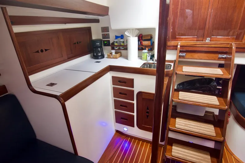 Volunteer Yacht Photos Pics Luxurious 1996 Custom Bruckmann Yachts interior with wooden cabinetry and modern kitchen amenities.