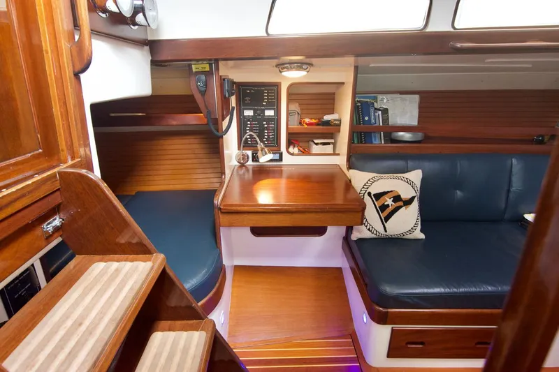 Volunteer Yacht Photos Pics Interior of 1996 Custom Bruckmann Yacht with wooden finish and blue seating.