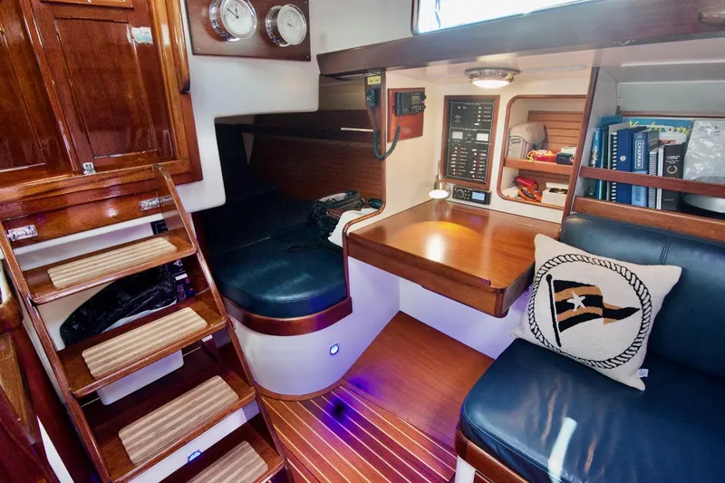 Volunteer Yacht Photos Pics Luxurious 1996 Bruckmann Yachts interior with wooden finishes and cozy seating area.