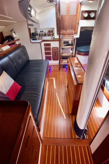 Volunteer Yacht Photos Pics Interior of 1996 Custom Bruckmann Yacht with wooden flooring and cozy seating area.