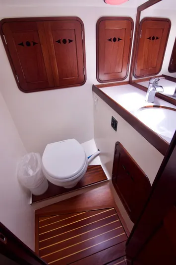 Volunteer Yacht Photos Pics Luxurious 1996 Bruckmann Yachts bathroom with wooden cabinetry and modern fixtures.