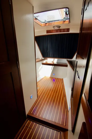 Volunteer Yacht Photos Pics Interior of 1996 Custom Bruckmann Yachts with wooden flooring and skylight.