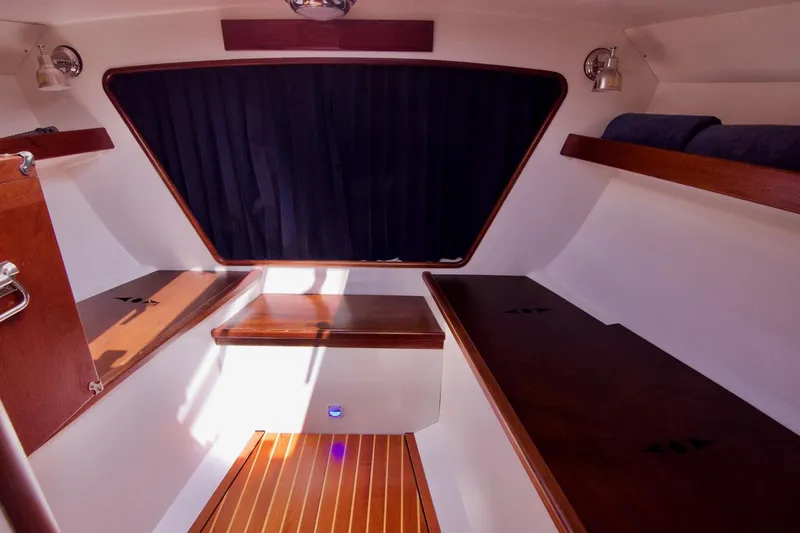 Volunteer Yacht Photos Pics Interior of 1996 Custom Bruckmann Yachts, featuring wood accents and cozy cabin space.