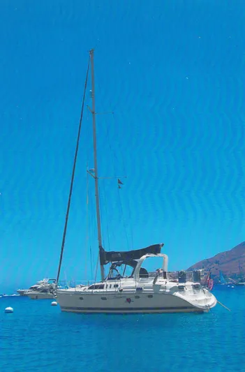 Romanc'n The Zea Yacht Photos Pics Sailboat Hunter 456 (1997) anchored in clear blue waters under a bright sky.