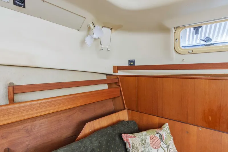 Romanc'n The Zea Yacht Photos Pics Cozy cabin interior of 1997 Hunter 456 sailboat with wooden paneling and a small window.