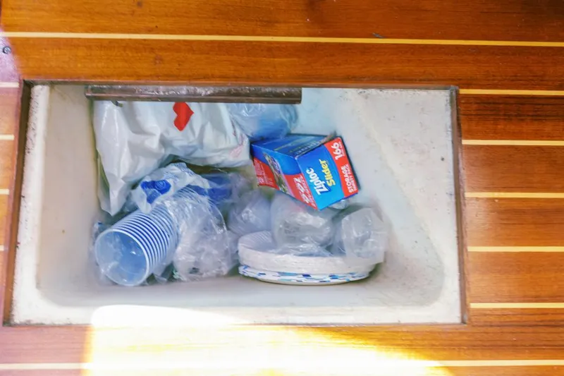 Romanc'n The Zea Yacht Photos Pics Storage compartment with plastic cups, plates, and Ziploc bags on a 1997 Hunter 456 boat.