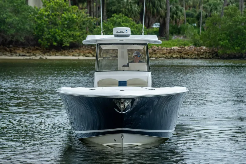  Yacht Photos Pics 2015 Belzona 32C boat on calm water with lush greenery in the background.