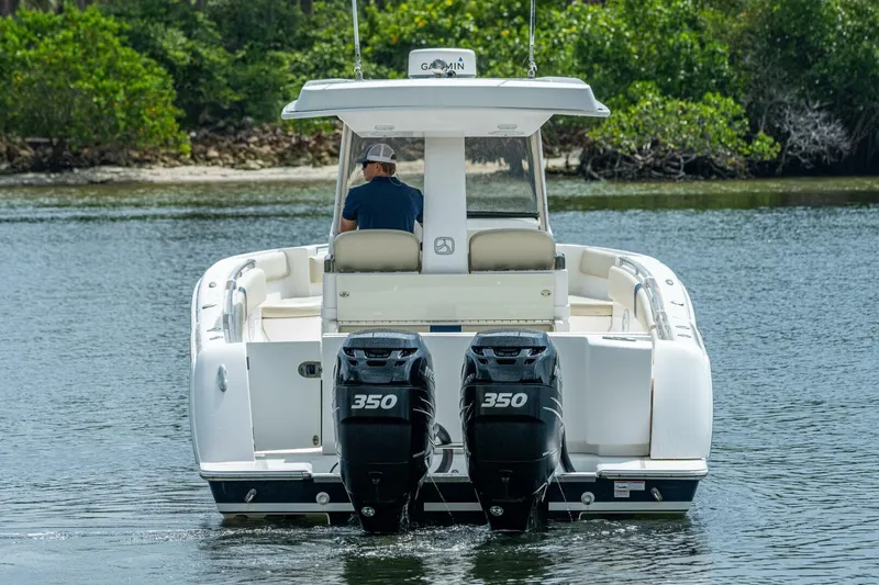  Yacht Photos Pics 2015 Belzona 32C boat with twin 350 horsepower engines on a calm waterway.