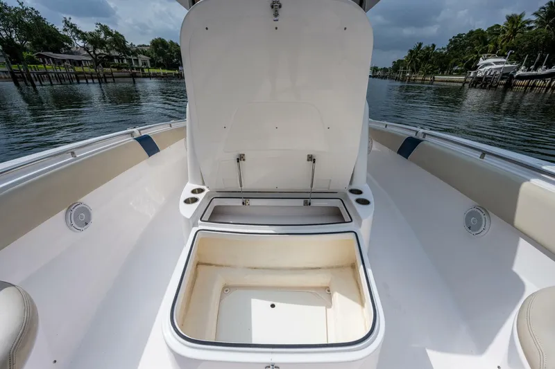  Yacht Photos Pics Open storage compartment on a 2015 Belzona 32C boat, docked by a scenic waterfront.