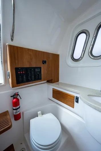  Yacht Photos Pics 2015 Belzona 32C boat bathroom with toilet, control panel, and fire extinguisher.