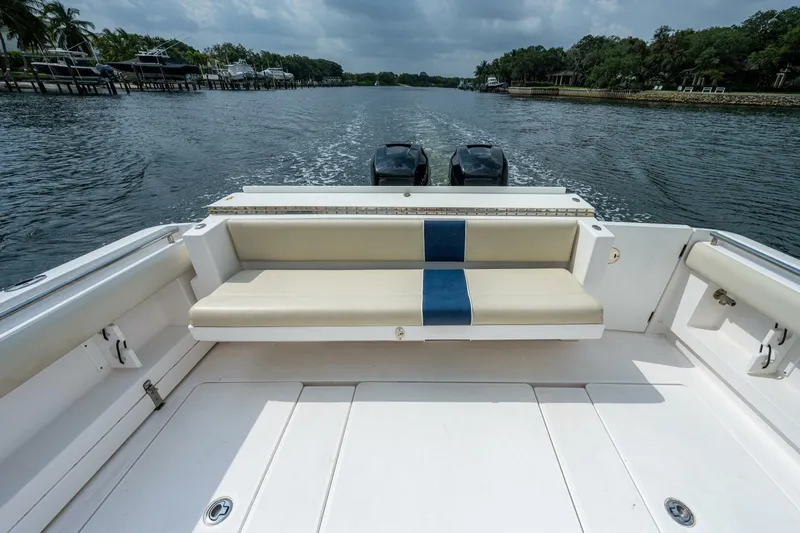  Yacht Photos Pics 2015 Belzona 32C boat with rear seating and twin outboard motors on a calm waterway.