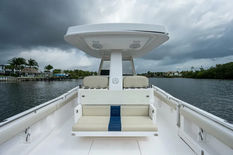 Yacht Photos Pics 2015 Belzona 32C boat interior with seating, under cloudy sky on calm water.