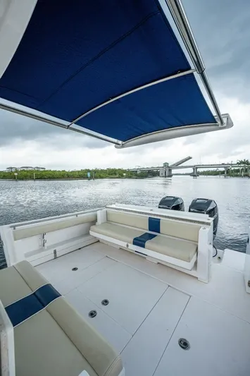  Yacht Photos Pics 2015 Belzona 32C boat with blue canopy and seating area.